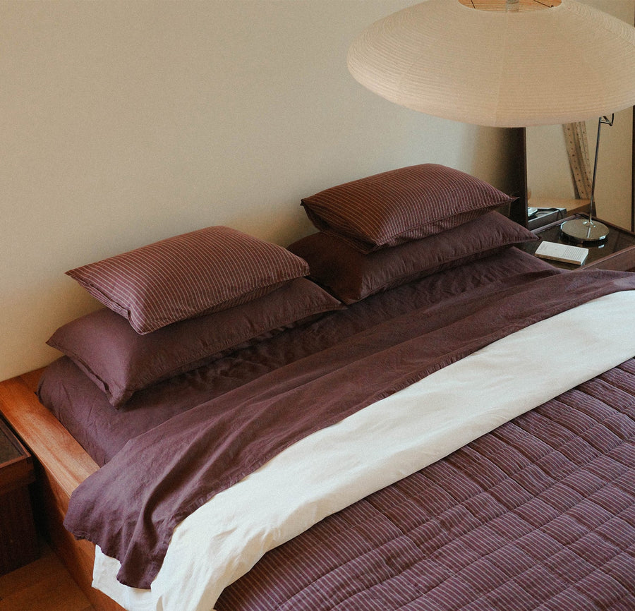 Morrow Soft Goods Pairing Mina Coverlet and Throw Pillows with Organic Percale Sheets in Pale Olive -bedroom lifestyle image.