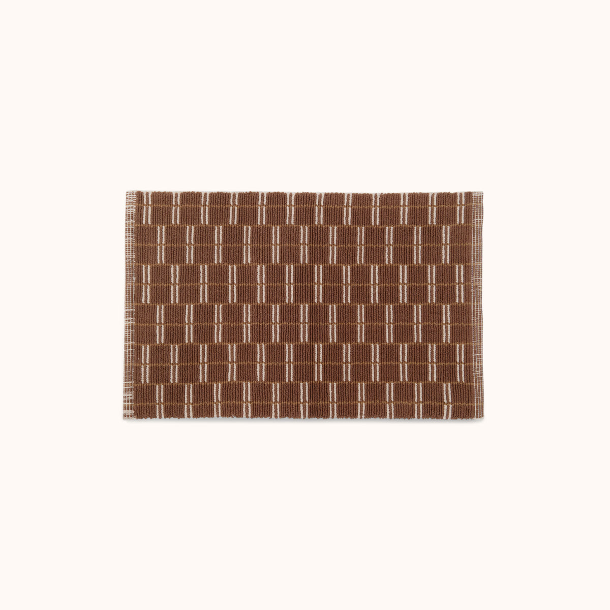 A rectangular brown and natural mat with a geometric pattern.