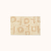 A rectangular beige bath mat with the word 'Mother' written in Korean characters, tufted in varying heights for a textured look.