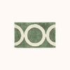 A green and beige geometric designed bath mat.