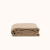 Folded beige duvet cover on a white background