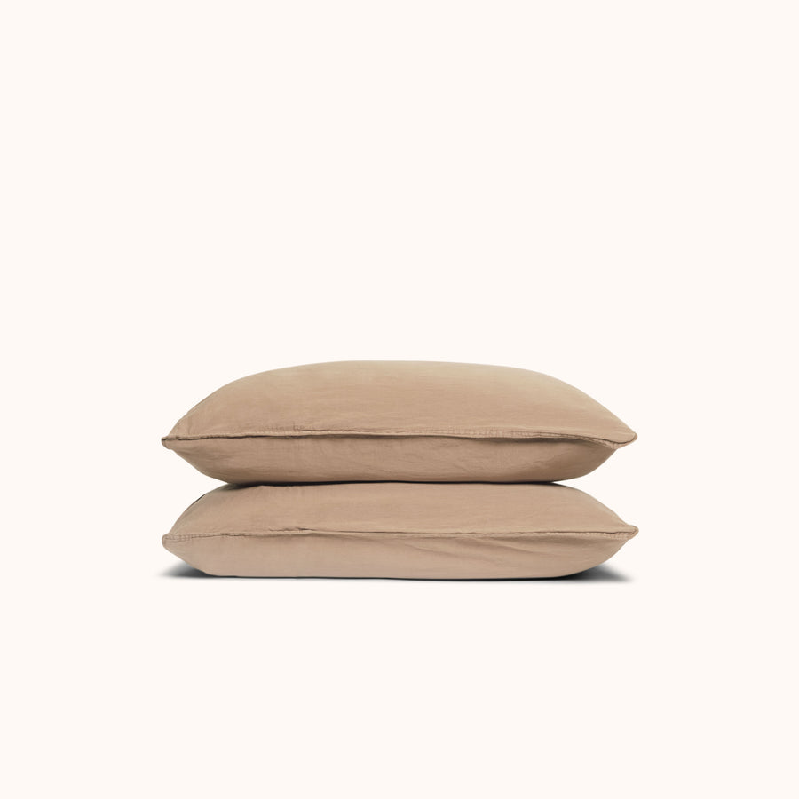 Two Dune / beige pillows stacked against a white background