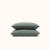 A set of two Pacific pillowcases made from organic matte sateen, stacked on top of each other against a white background