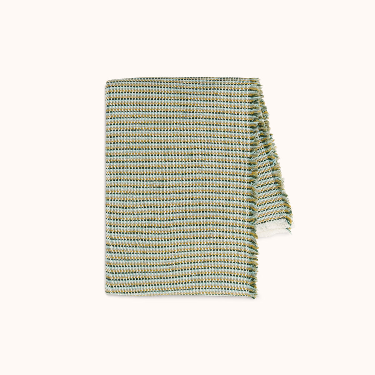 A blanket with a subtle woven stripe pattern in golden yellow, blue, and green hues.