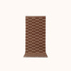 A brown and natural colored runner mat with a geometric pattern, displayed on a plain background.