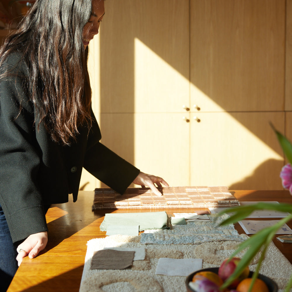 Stephanie browsing textile samples in the studio