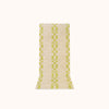 A rectangular, bath mat with a geometric pattern in lime and ecru colors.