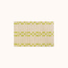 A rectangular, bathmat with a geometric pattern in green and beige colors.