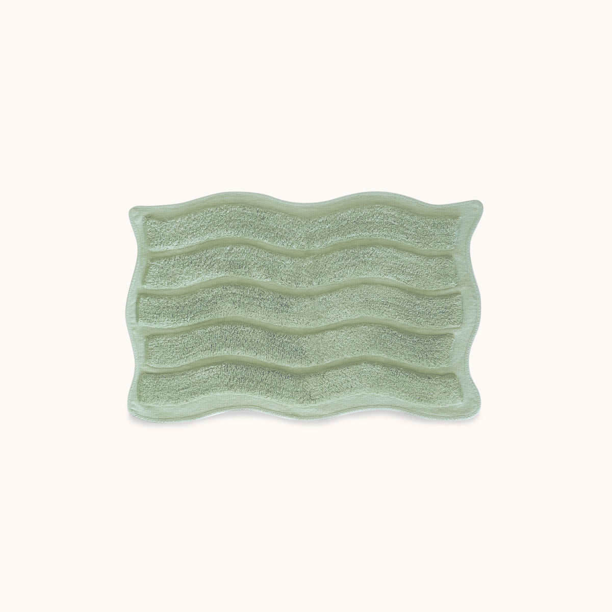 Green textured rectangular bath mat with alternating shag heights on a white background