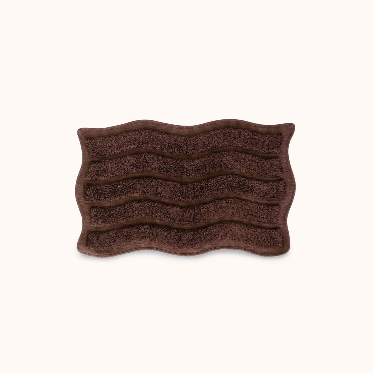 Brown textured bath mat with wavy pattern and alternating shag heights on a white background