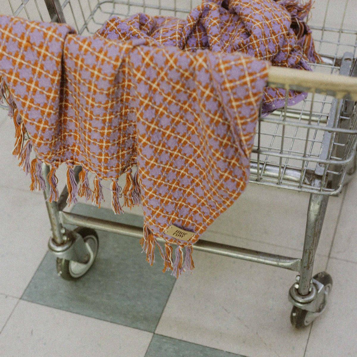 A closer angle of the Rosina blanket in a vintage laundry basket