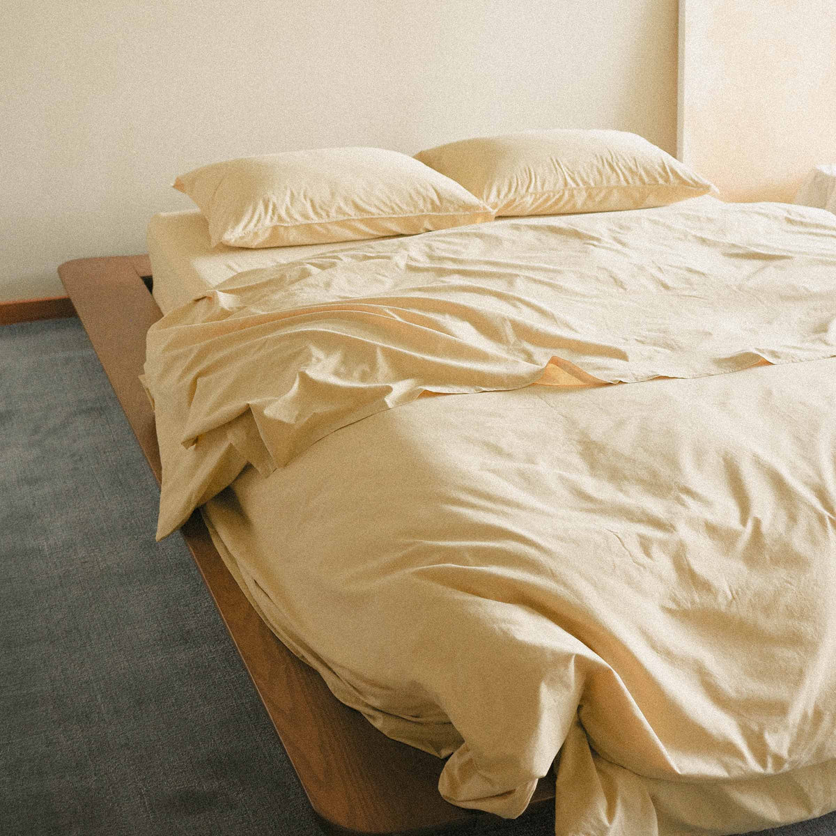 Yellow duvet cover on a bed in a minimalistic room