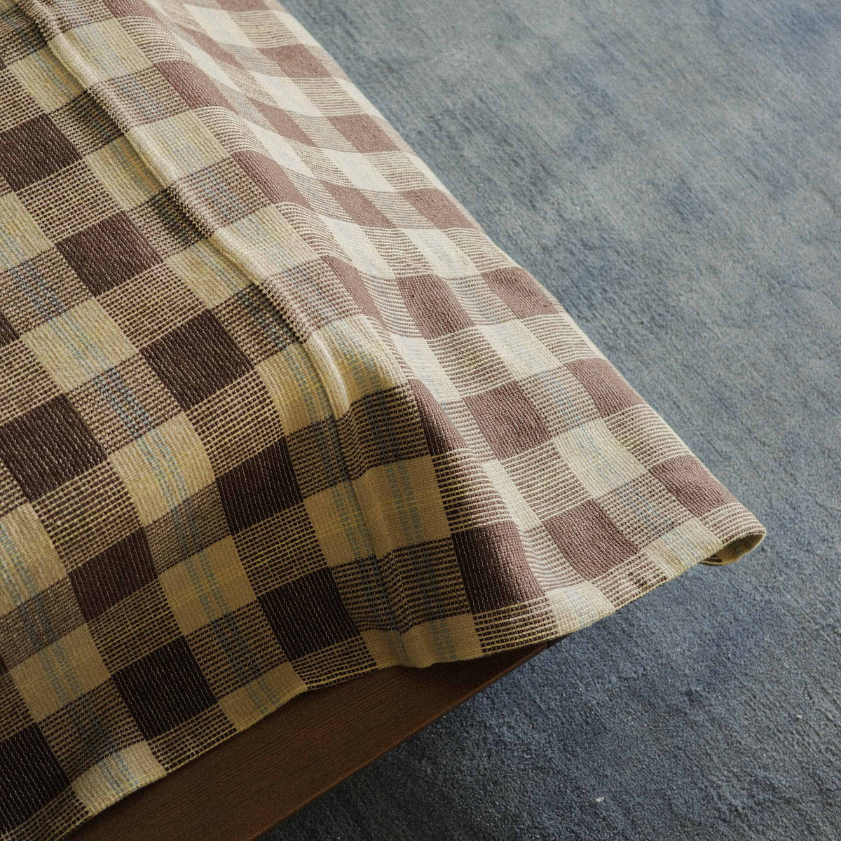 A close up of the Mina Bed Cover which is checkered 