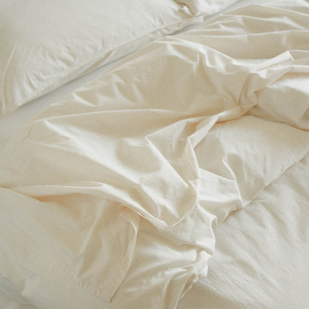 Close-up of cream duvet cover on a bed