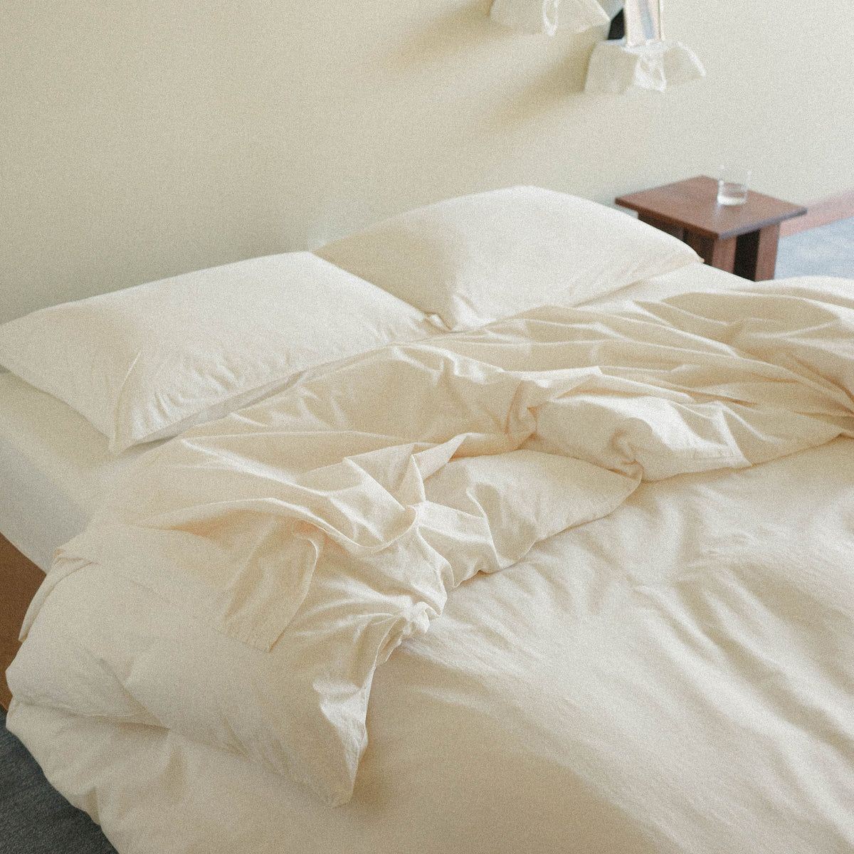 Cream duvet cover and pillows in a bedroom setting