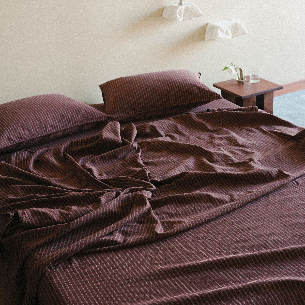 Brown Striped bedspread on a bed in a bedroom setting.