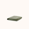 Folded striped terry bath towel in green and beige colors