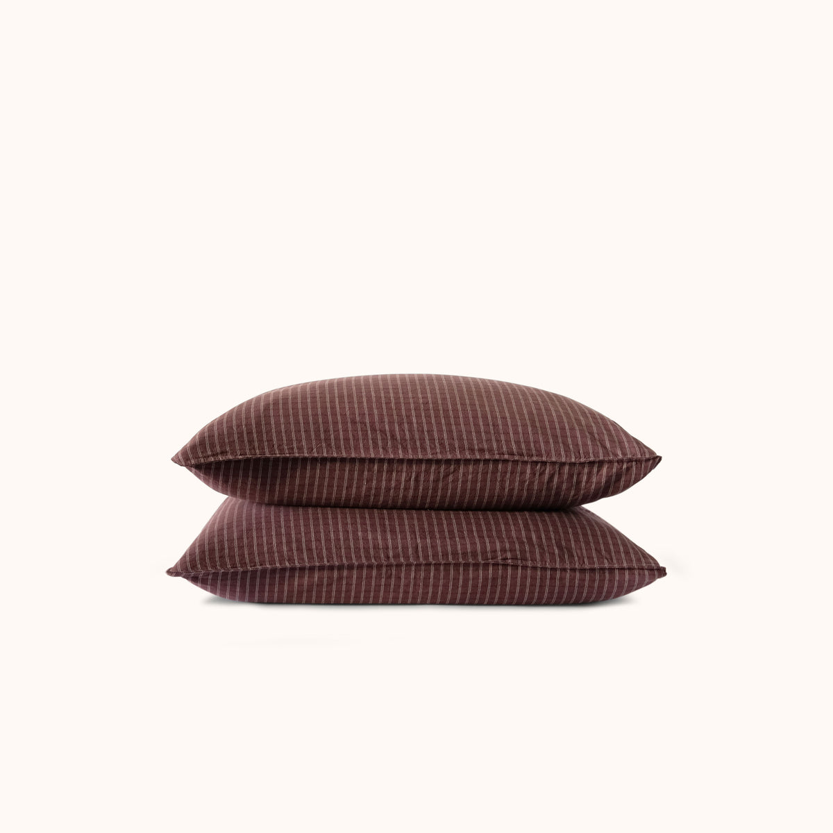 Two brown striped pillows against a white background