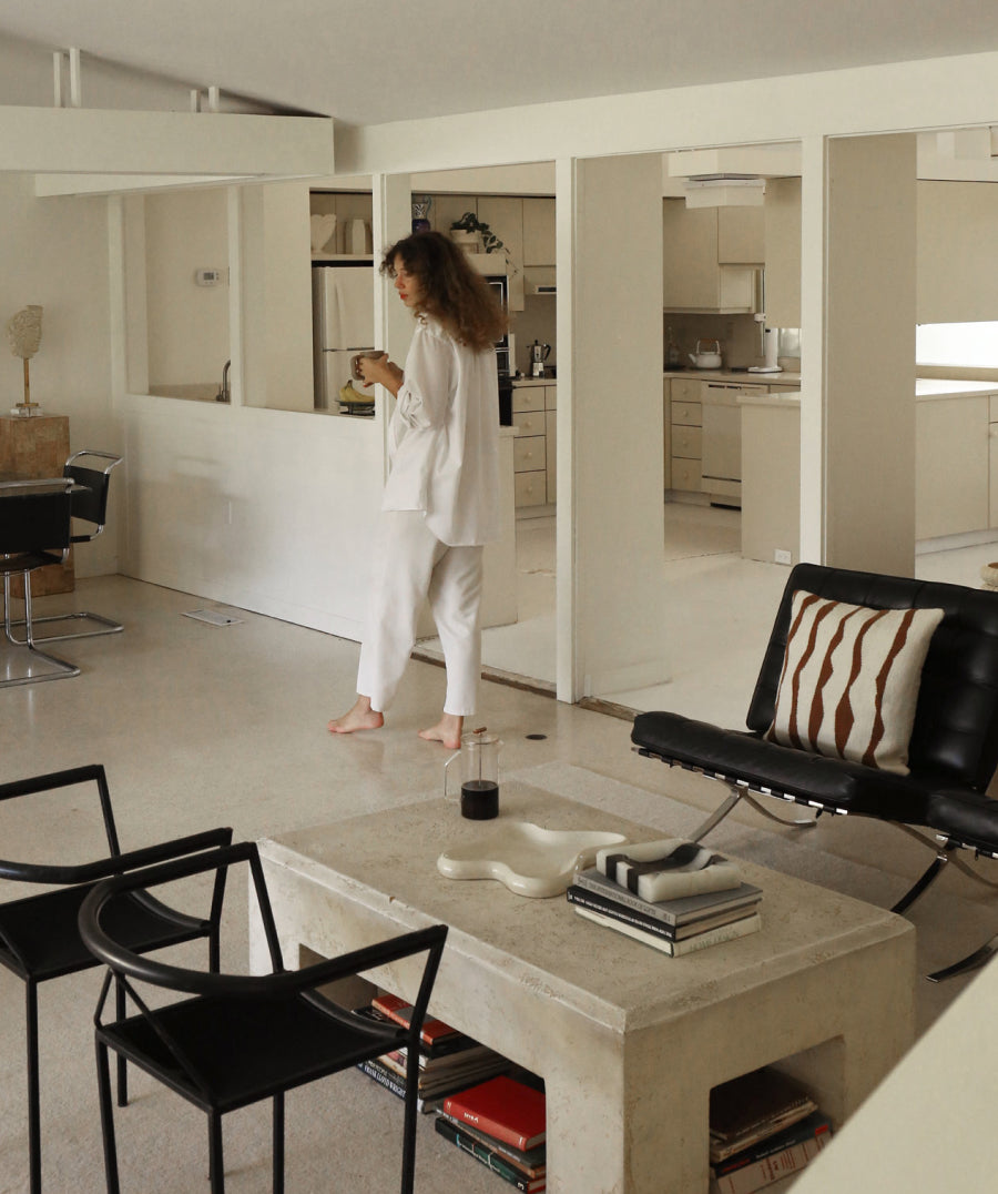 Woman walking through a modern living room 