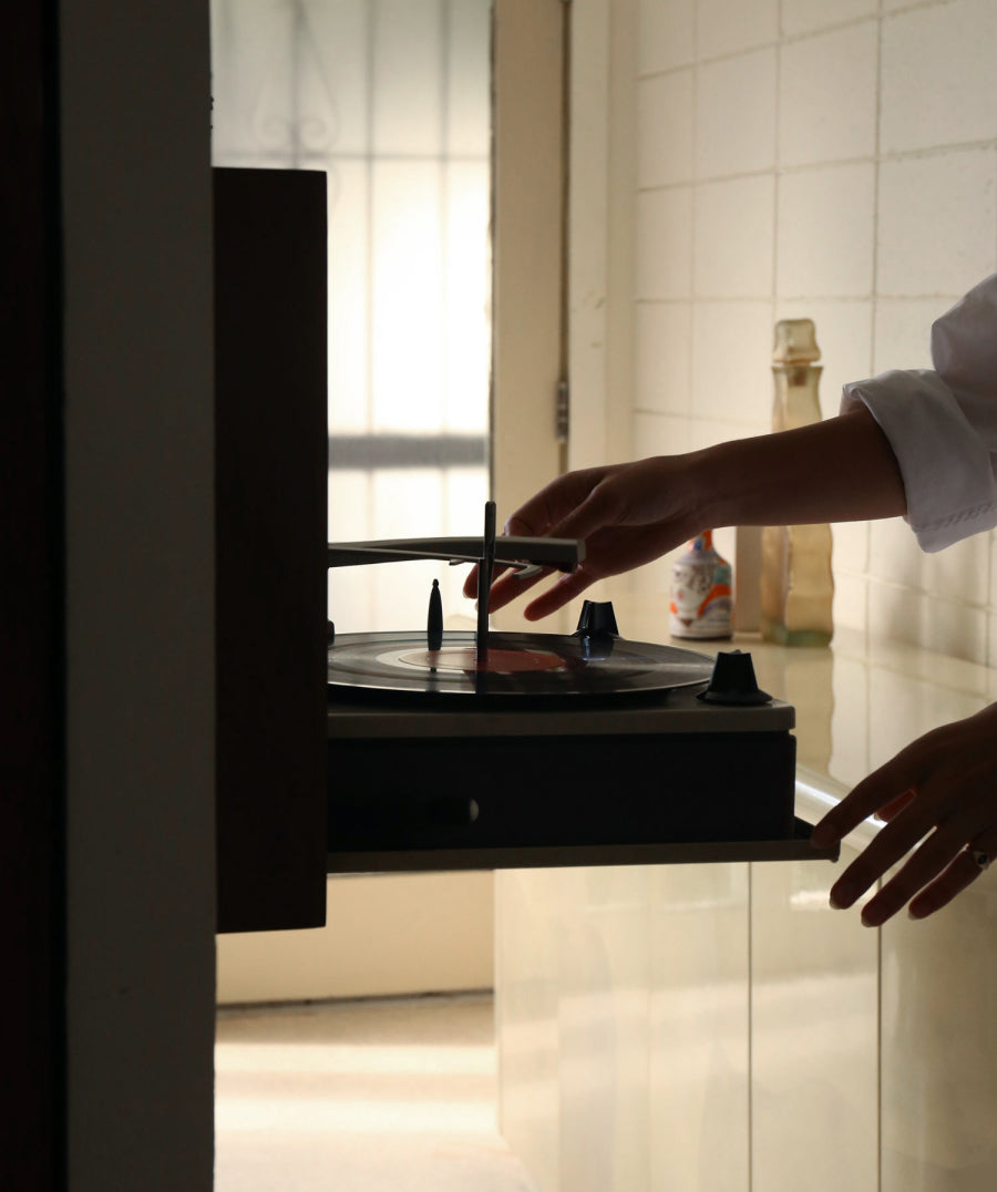 Person moving the needle on a record player