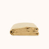 Yellow folded duvet cover on a white background