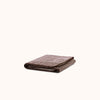 Folded striped terry bath towel in brown and ecru color, with a soft textured surface.