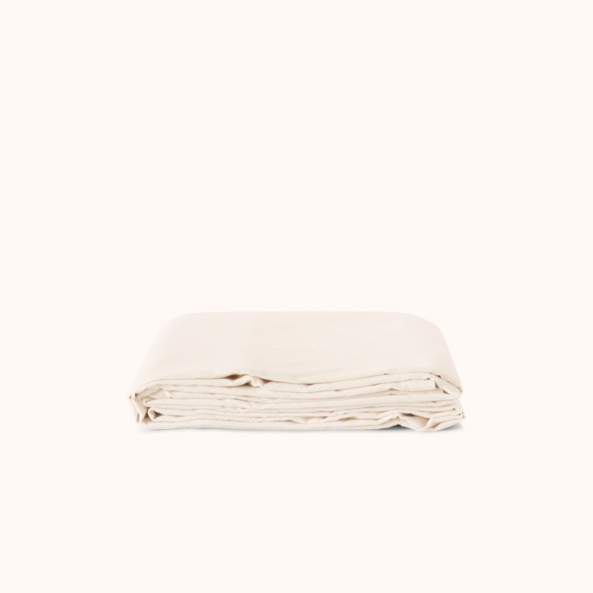 Folded cream flat sheet on a white background