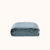 Folded duvet cover in a deep blue color, showcasing its texture and material.