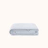 Folded light blue duvet cover on a white background