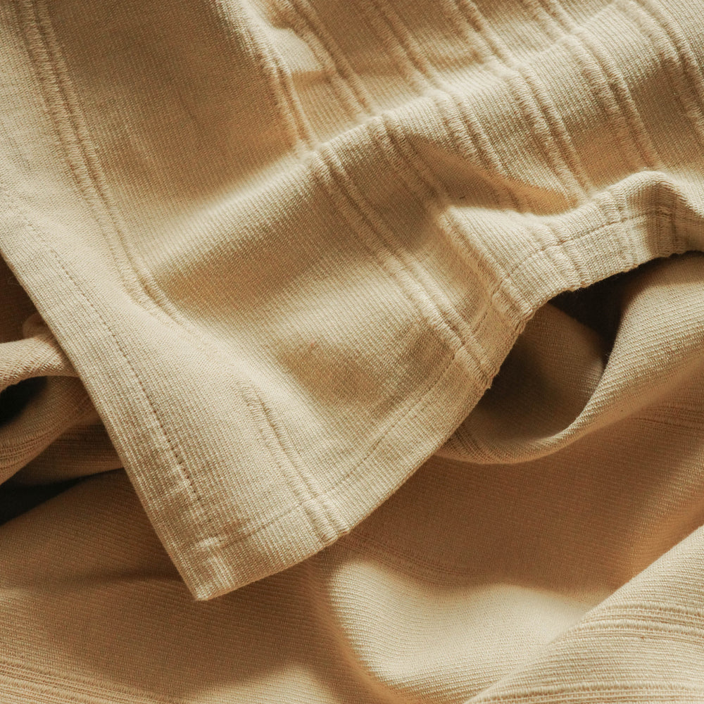 Detail of light yellow textured fabric