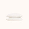 Two white pillows stacked on a white background