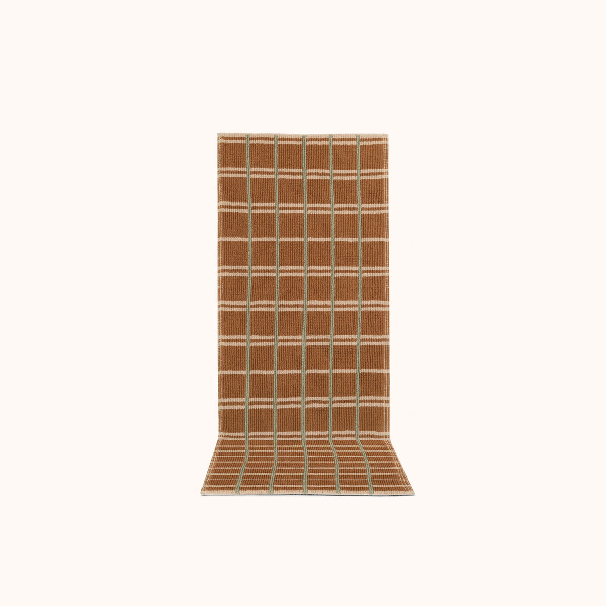 A rectangular runner with a geometric pattern featuring small tight loops, in a hazelnut brown color, with jade and cream accents.